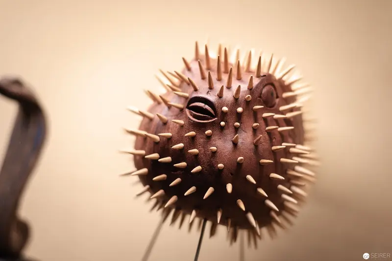 Spiked Ceramic Sculpture Resembling Pufferfish with Stylized Eye