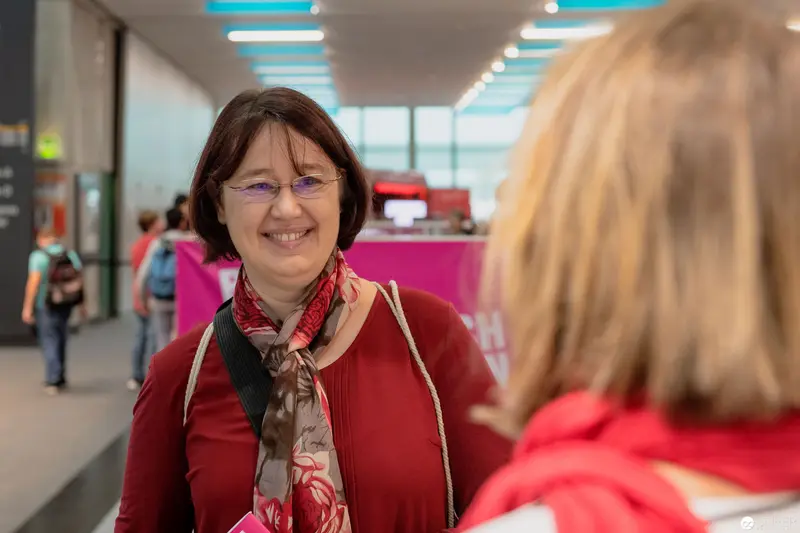 Janett Cernohuby Smiling in Red at Public Space Event