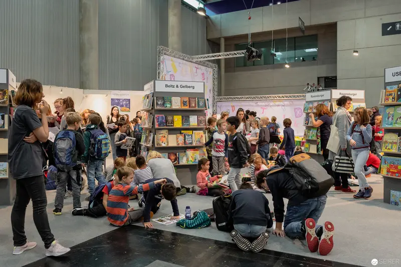 Buch Wien Literary Fair: Children Exploring Books at Publishers' Exhibition Stand