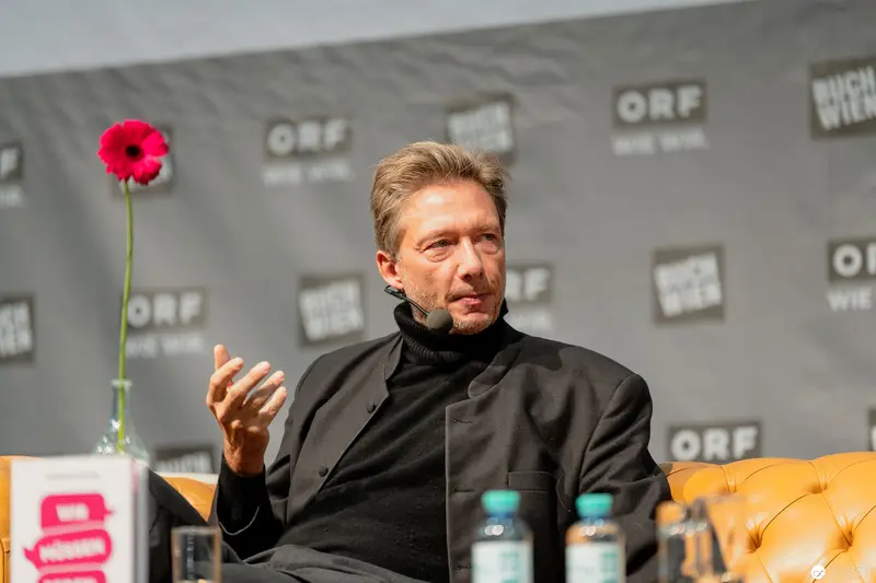 ORF Event Speaker in Black Turtleneck with Red Poppy Accent