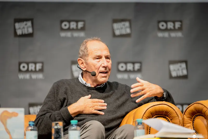 Distinguished Speaker at ORF Event Gestures During Passionate Panel Discussion