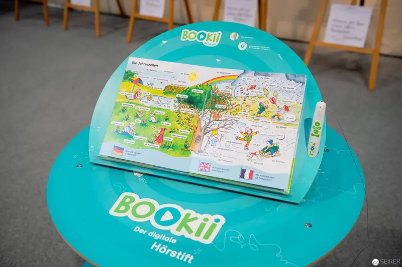 Bookii Digital Listening Device Displayed on Teal Circular Platform