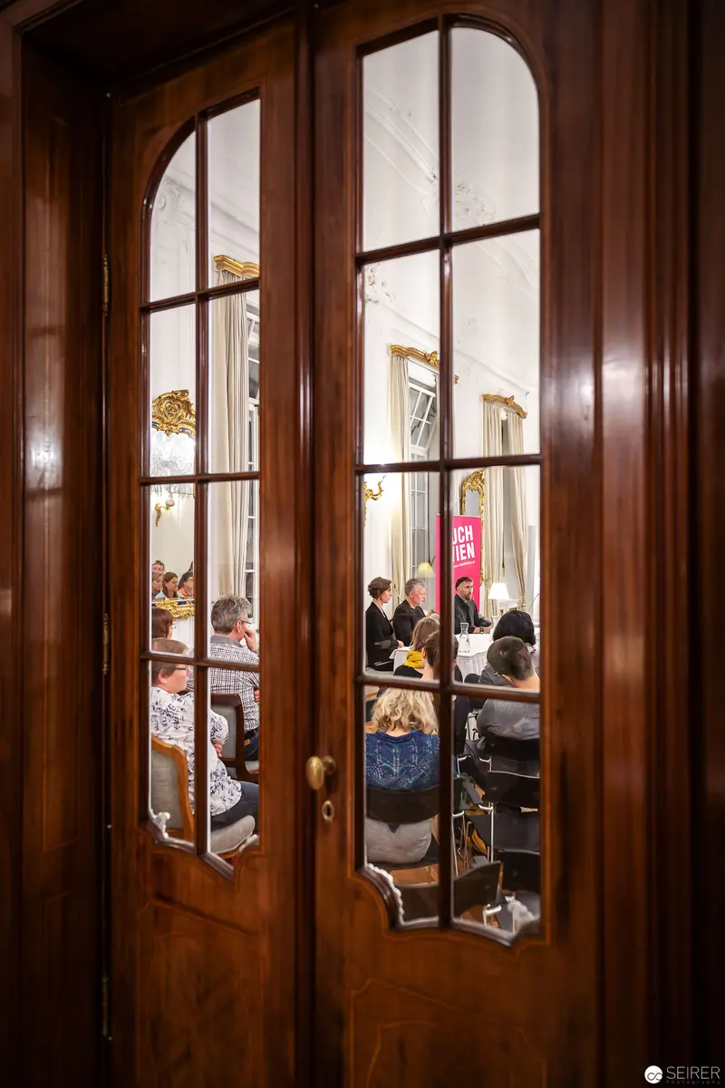 Arne Dahl's Book Reading at Buch Wien 2018 Through Wooden French Doors