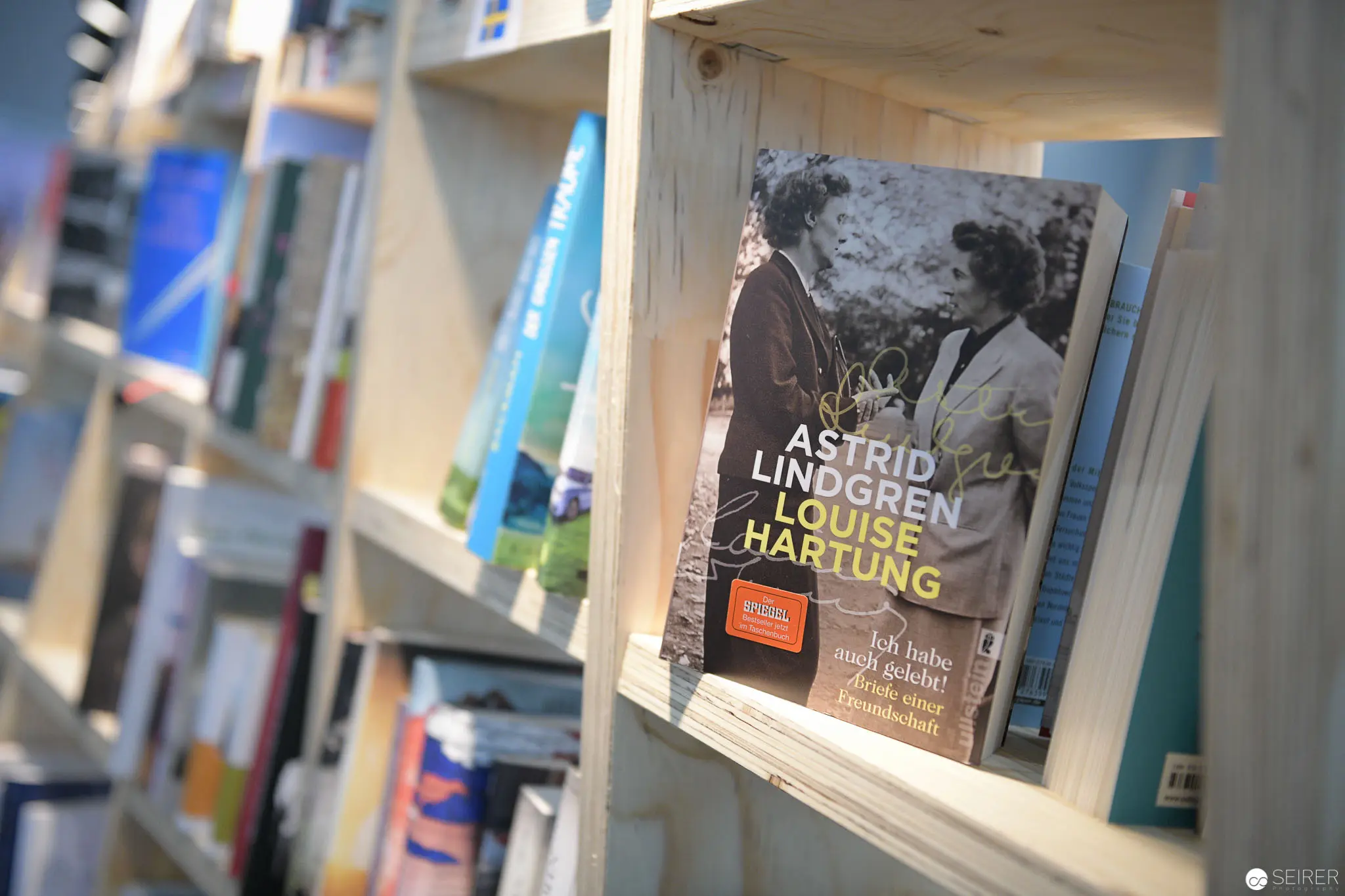 Book Display with Astrid Lindgren and Louise Hartung Biography on Wooden Shelf