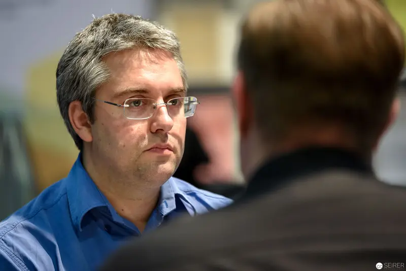 Intense Professional Interaction: Mid-Level Executive in Blue Shirt During Consultation