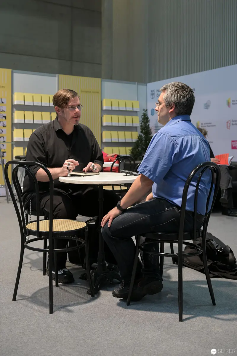 Two Professionals in Dialogue at Contemporary Business Meeting