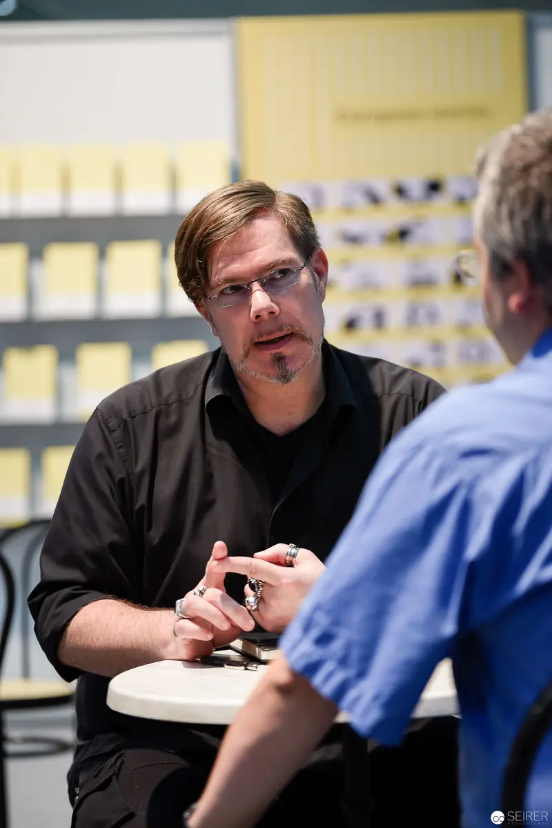Professional Discussion in Office Setting with Gesturing Participant