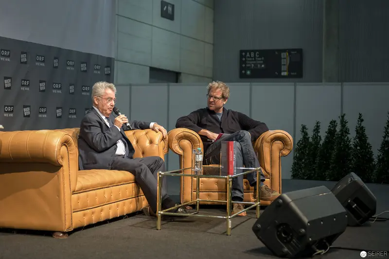 Heinz Fischer in Conversation at Public Event on Yellow Leather Armchairs