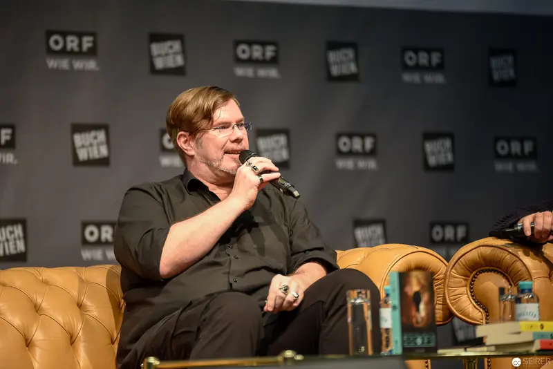 Markus Heitz Speaking at Buch Wien with a microphone