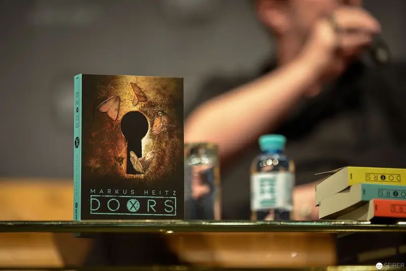 Markus Heitz's "Doors" Book Displayed with Mysterious Keyhole Cover Design