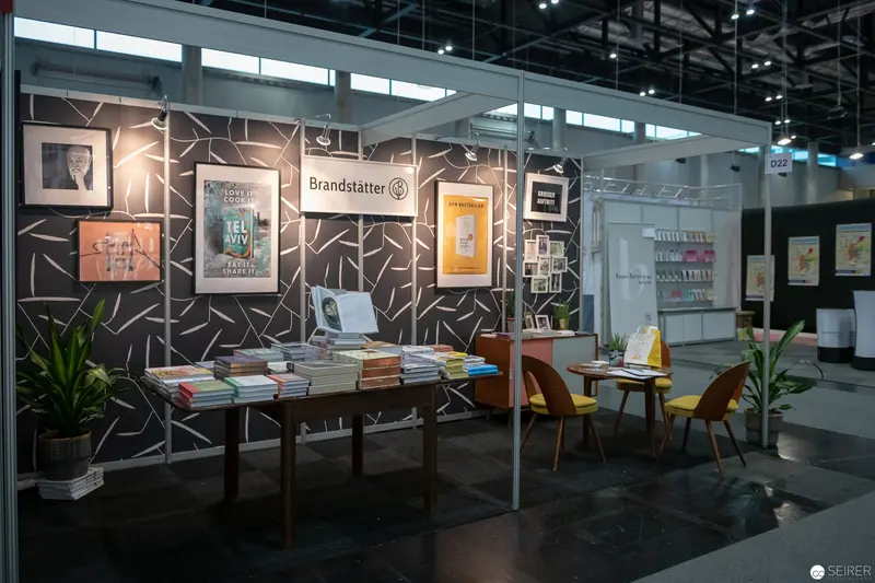 Brandstätter Publishing Booth at Book Fair Displaying Editorial Diversity and Design