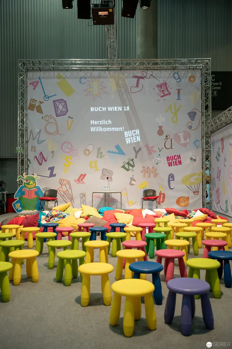 Buch Wien Event: Colorful Children's Stools Arranged for Literary Presentation