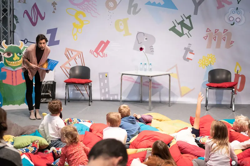 Children's Storytelling Session with Colorful Literary Backdrop