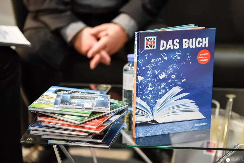 "Das Buch" Publication Materials with Stacked Books and Blue Cover Display