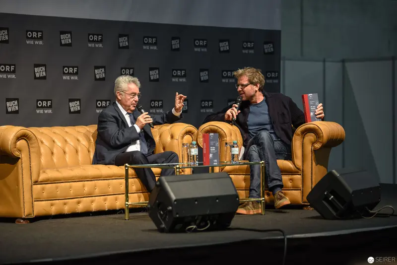 ORF Event: Two Distinguished Speakers in Conversation on Yellow Leather Chairs