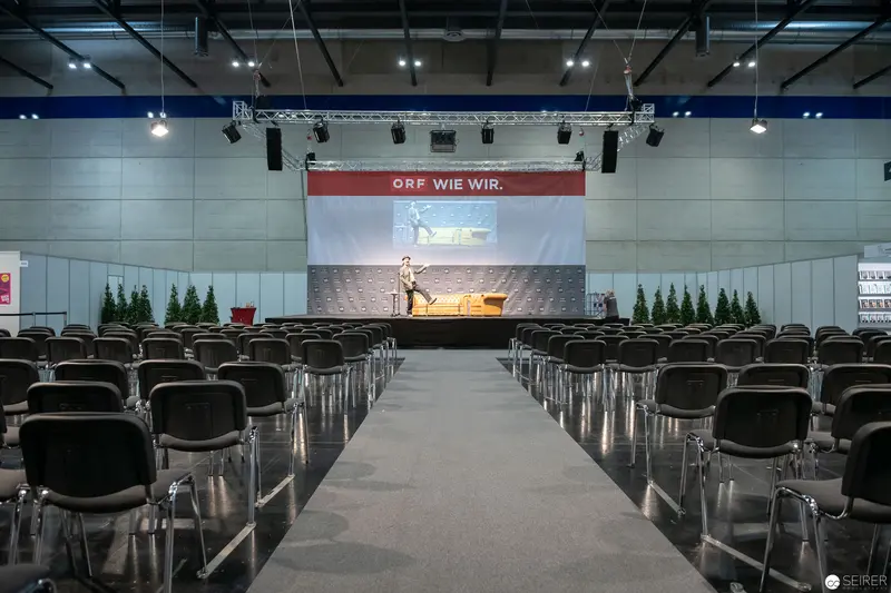 ORF Corporate Event Setup with Empty Conference Hall and Staged Presentation