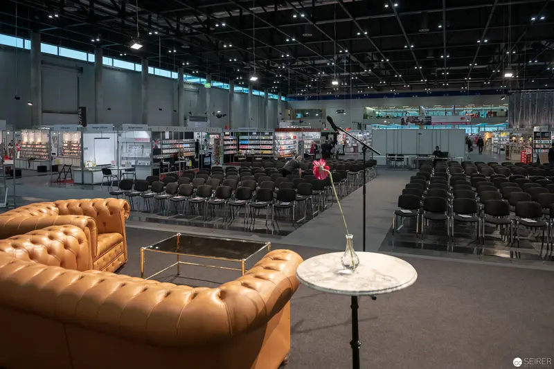 Industrial Exposition Lounge with Leather Seating and Modular Exhibition Space