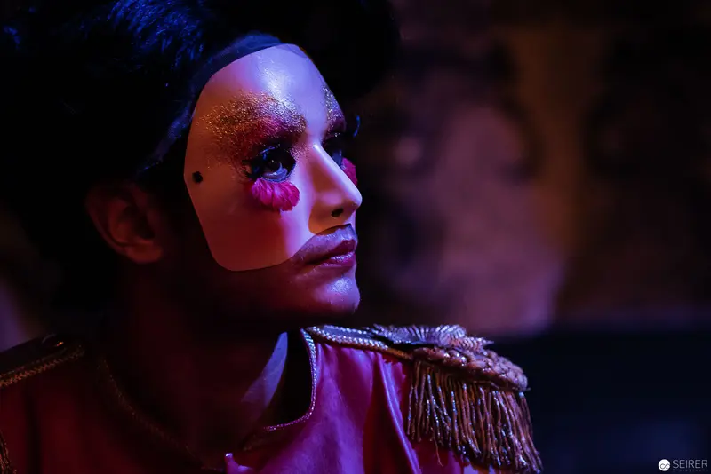 Lakrimosa's Theatrical Portrait in Dramatic Magenta and Blue Stage Lighting