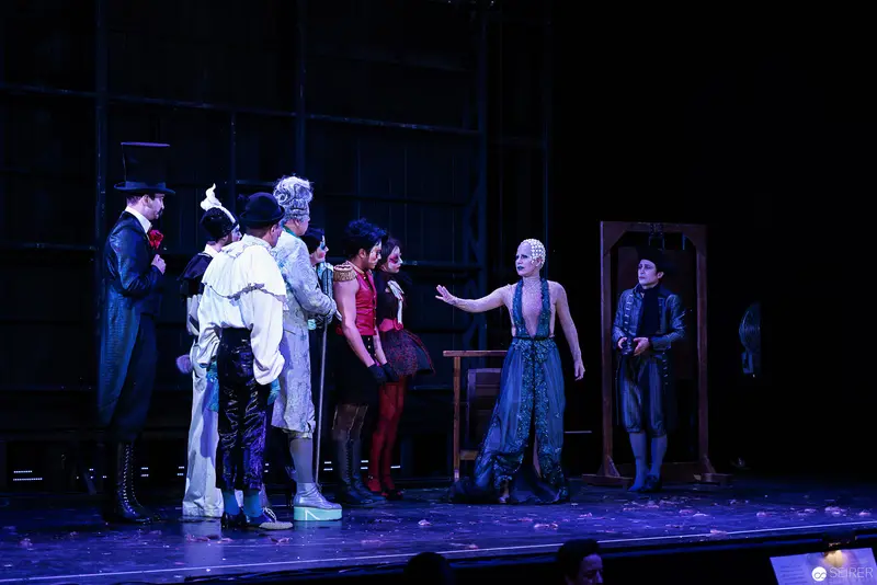 Theatrical Scene with Costumed Performers in Blue-Tinted Stage Lighting