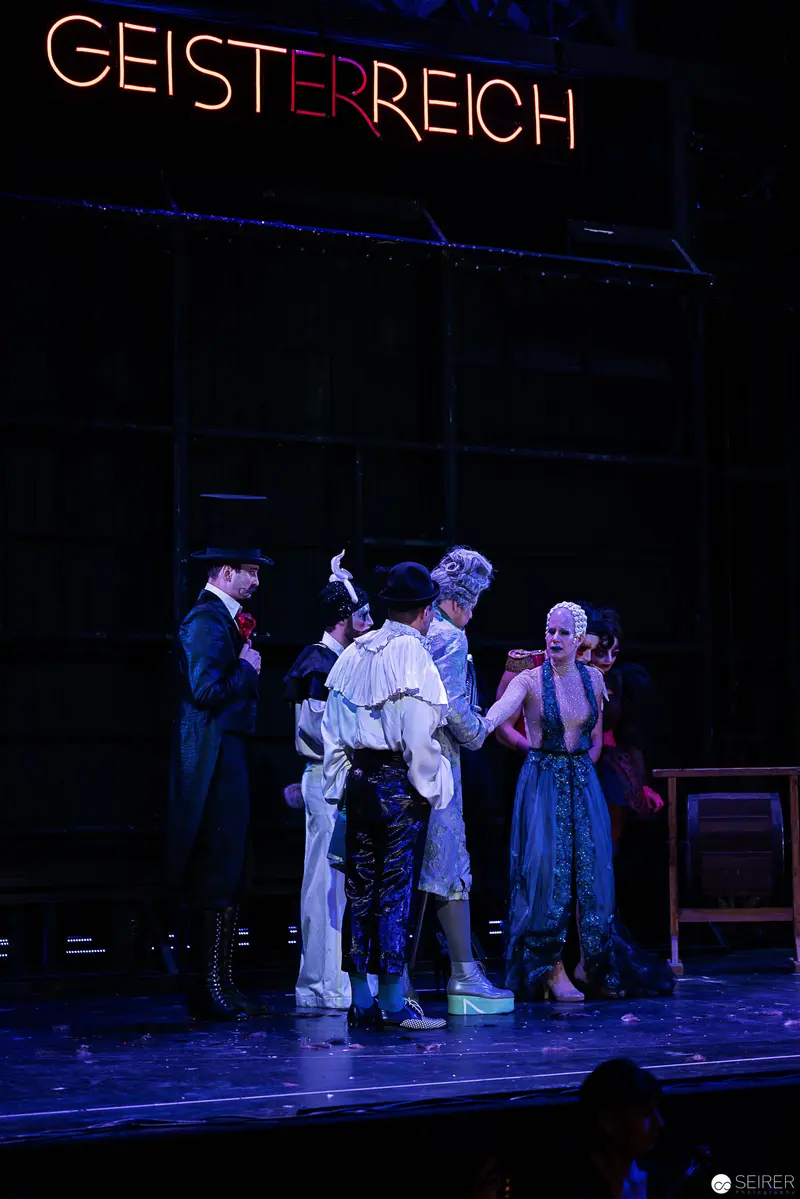 Geisterreich Stage: Dramatic Ensemble in Blue-Toned Theatrical Lighting