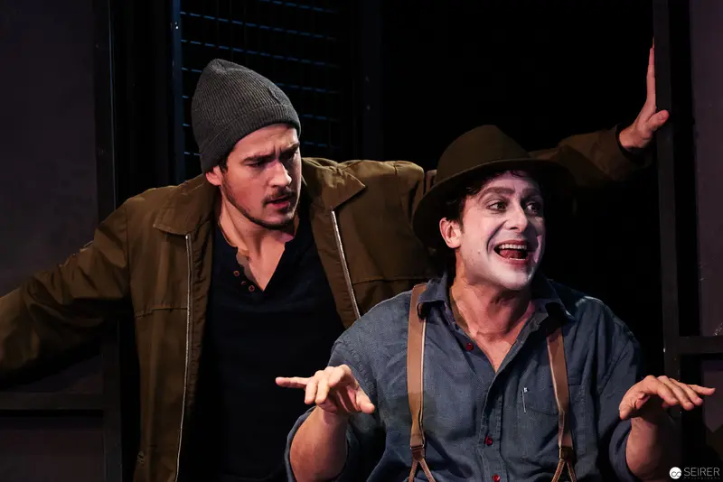 Theatrical Performance Depicting Intense Dramatic Interaction Between Two Male Actors