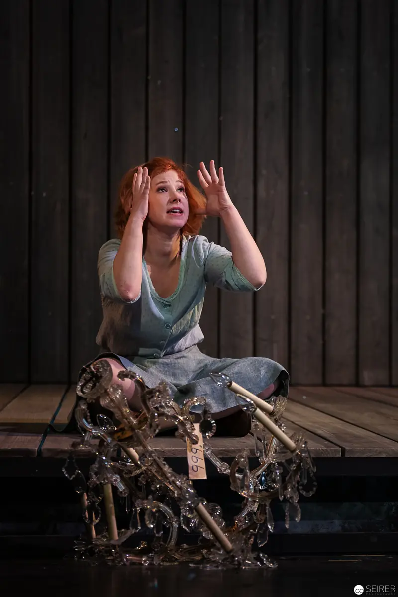 Theatrical Performance: Lakrimosa Seated Amid Intricate Mechanical Apparatus