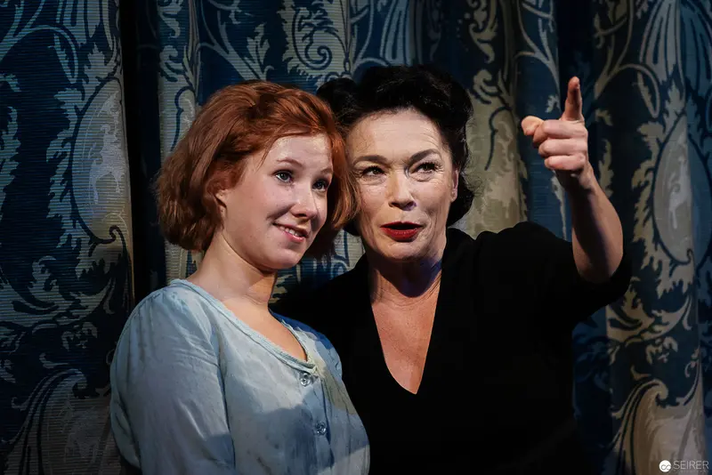 Lakrimosa and Companion Posing Against Ornate Theatrical Backdrop