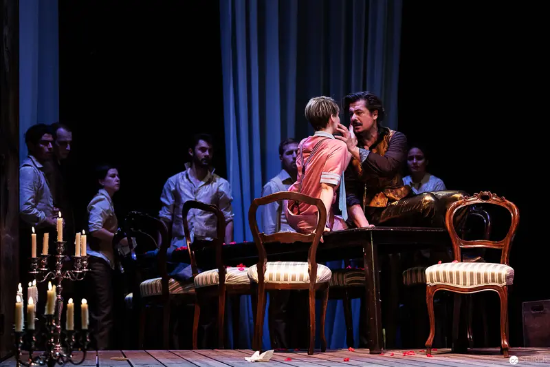 Lakrimosa and Bustorius Engage in Dramatic Confrontation on Candlelit Stage