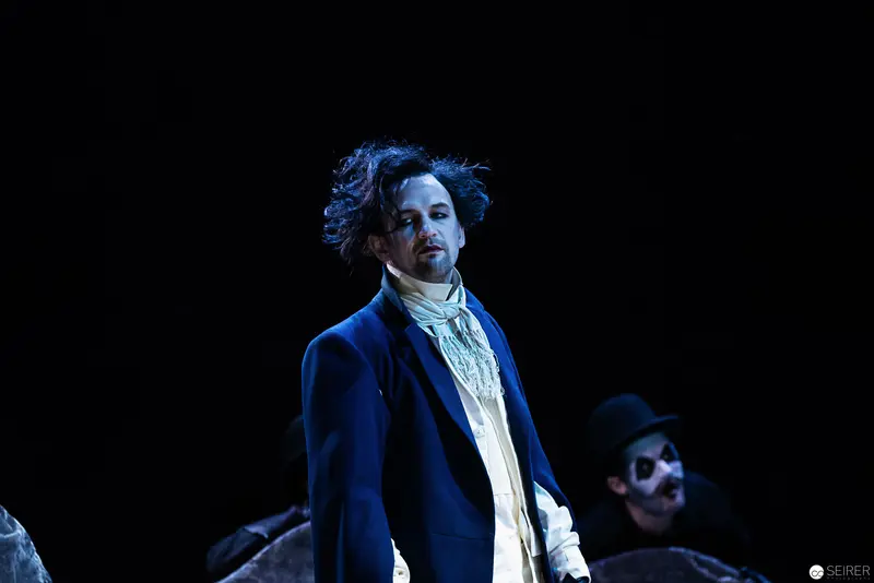 Patrick Seletzky as Theatrical Magician in Dramatic Blue-Toned Stage Composition