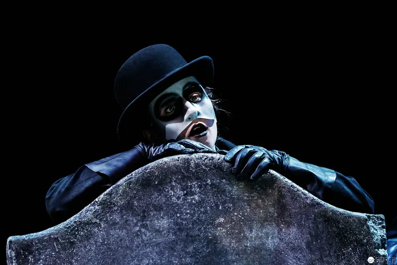 Melancholic Mime Leaning on Gravestone in Dramatic Theatrical Pose