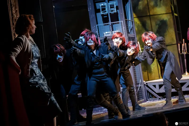 Theatrical Performance Featuring Masked Performers in Dynamic Staged Interaction
