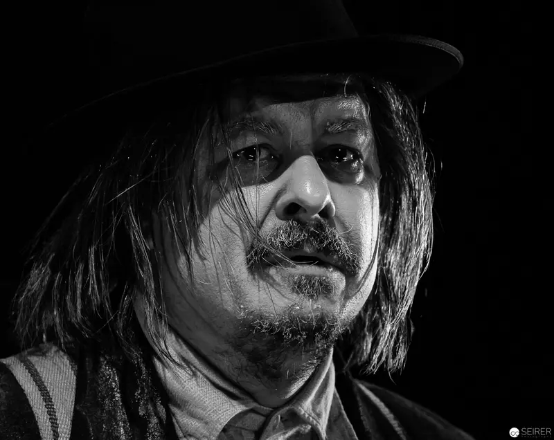 Dramatic Black and White Portrait of Musician with Intense Gaze