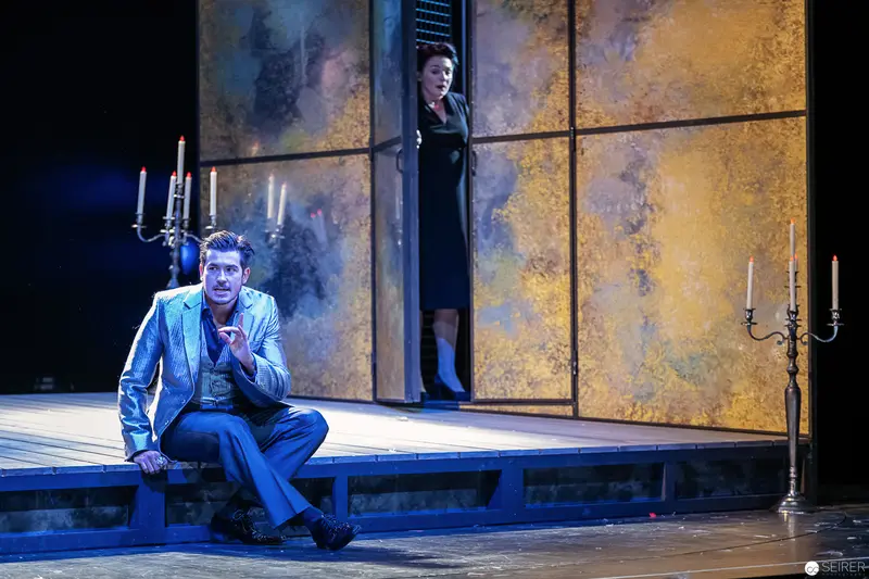 Alexandra Krismer and Patrick Seletzky in Dramatic Theatrical Staging with Candelabras