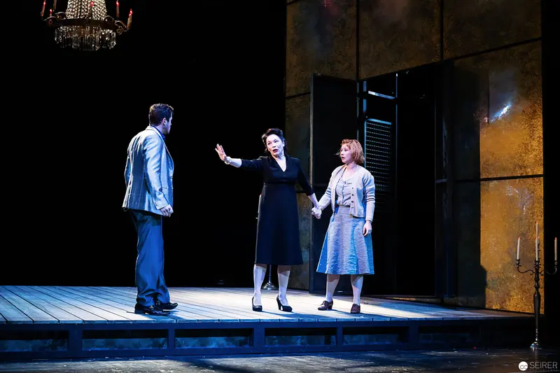 Theatrical Scene with Three Performers on Wooden Stage Set