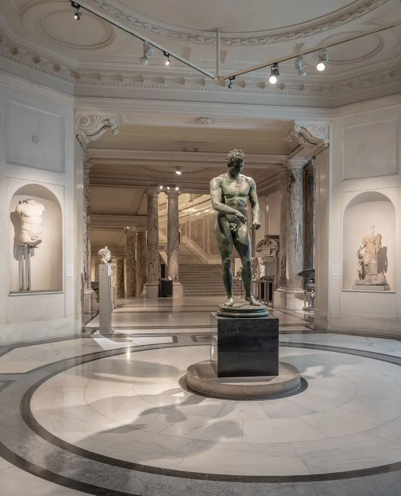 Classical Sculpture Centered in Ornate Museum Gallery with Elegant Architectural Details
