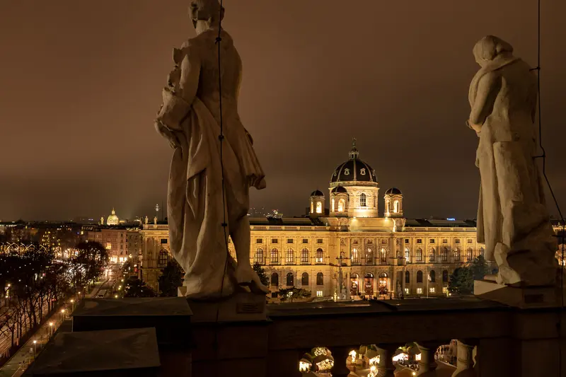 Nighttime View of Architectural Monument with Statues in Foreground