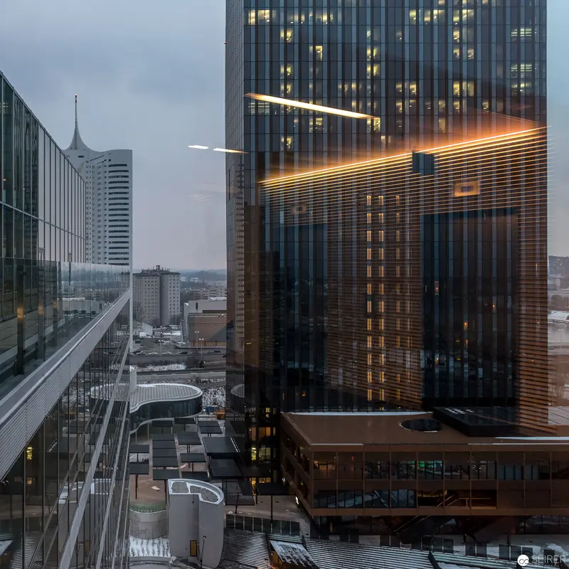 Urban Architectural Landscape with Illuminated Glass and Steel Towers at Dusk