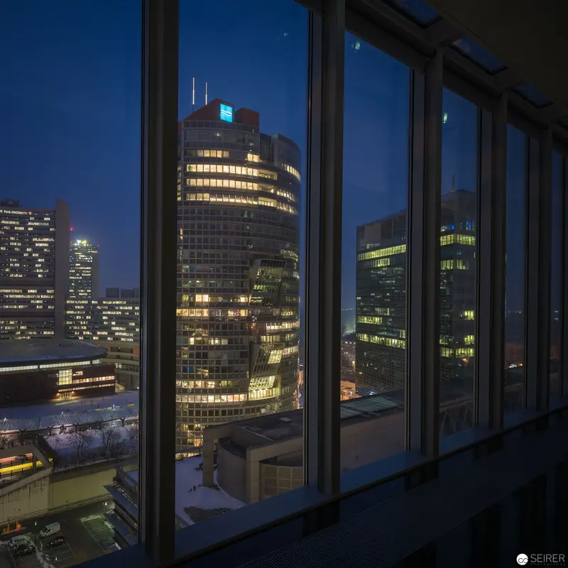 Night Cityscape with Office Buildings Viewed Through Large Windows