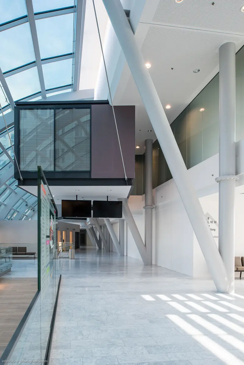 Modern Architectural Interior with Geometric Glass and White Structural Elements