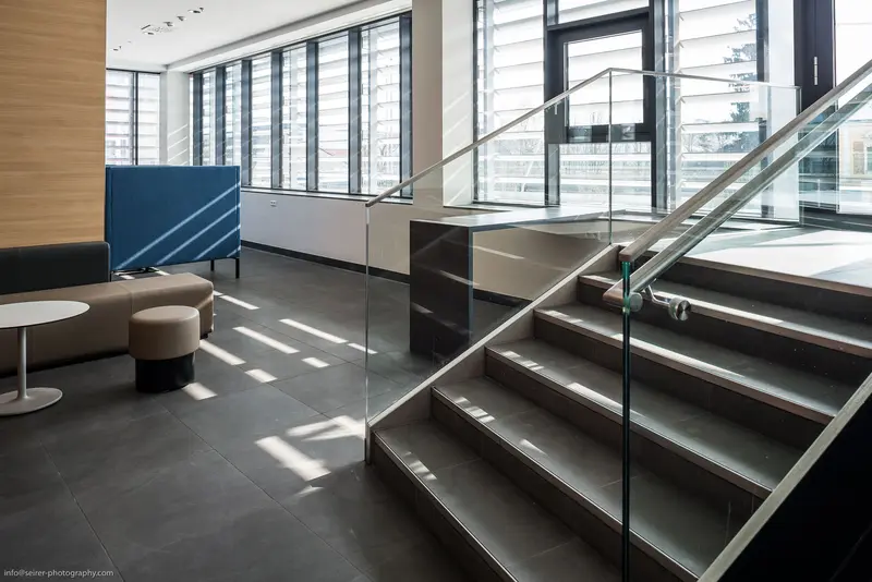Modern Office Interior with Glass Staircase and Minimalist Seating Area