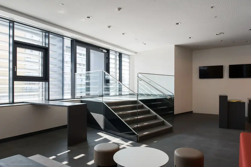 Modern Interior with Glass Staircase and Minimalist Lounge Seating
