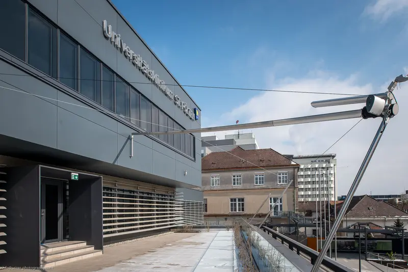 Modern Architectural Intersection: Urban Campus with Structural Steel Bridge Element