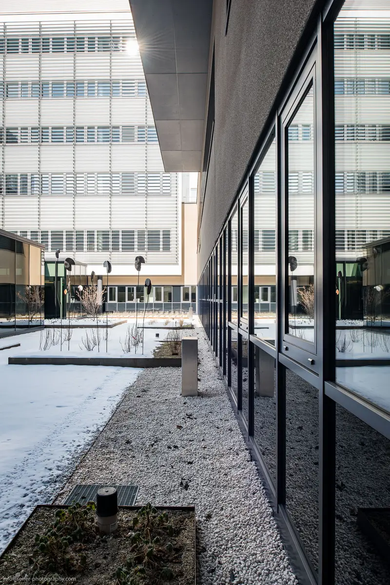 Modern Architectural Intersection: Glass, Concrete, and Winter Landscape