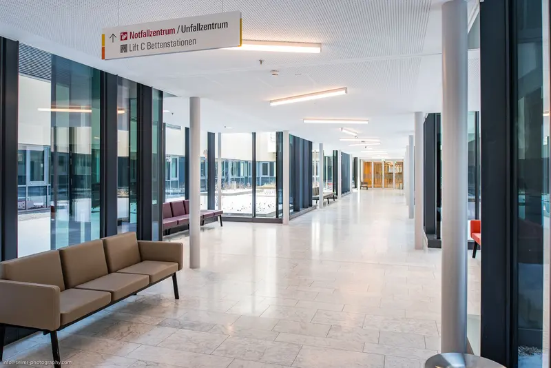 Modern Hospital Corridor with Minimalist Design and Wayfinding Signage