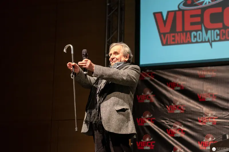 Sylvester McCoy Performing at Vienna ComicCon 2018, Microphone and Cane in Hand