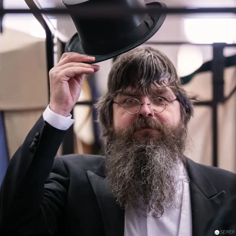 Bearded Gentleman in Black Hat Adjusting Headwear at Vienna Comic Convention
