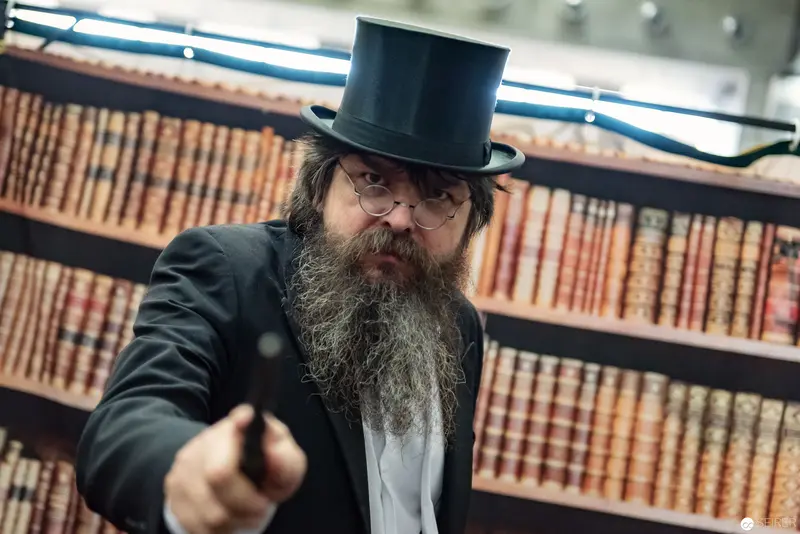 Scholarly Gentleman in Top Hat Amid Vintage Library Shelves