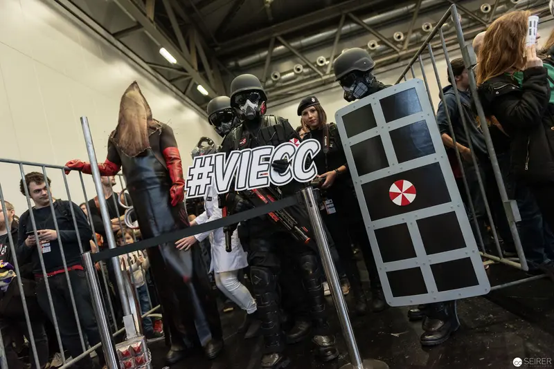 VIECC 2018 Cosplayers in Tactical Gear Pose with Hashtag Sign Behind Barriers