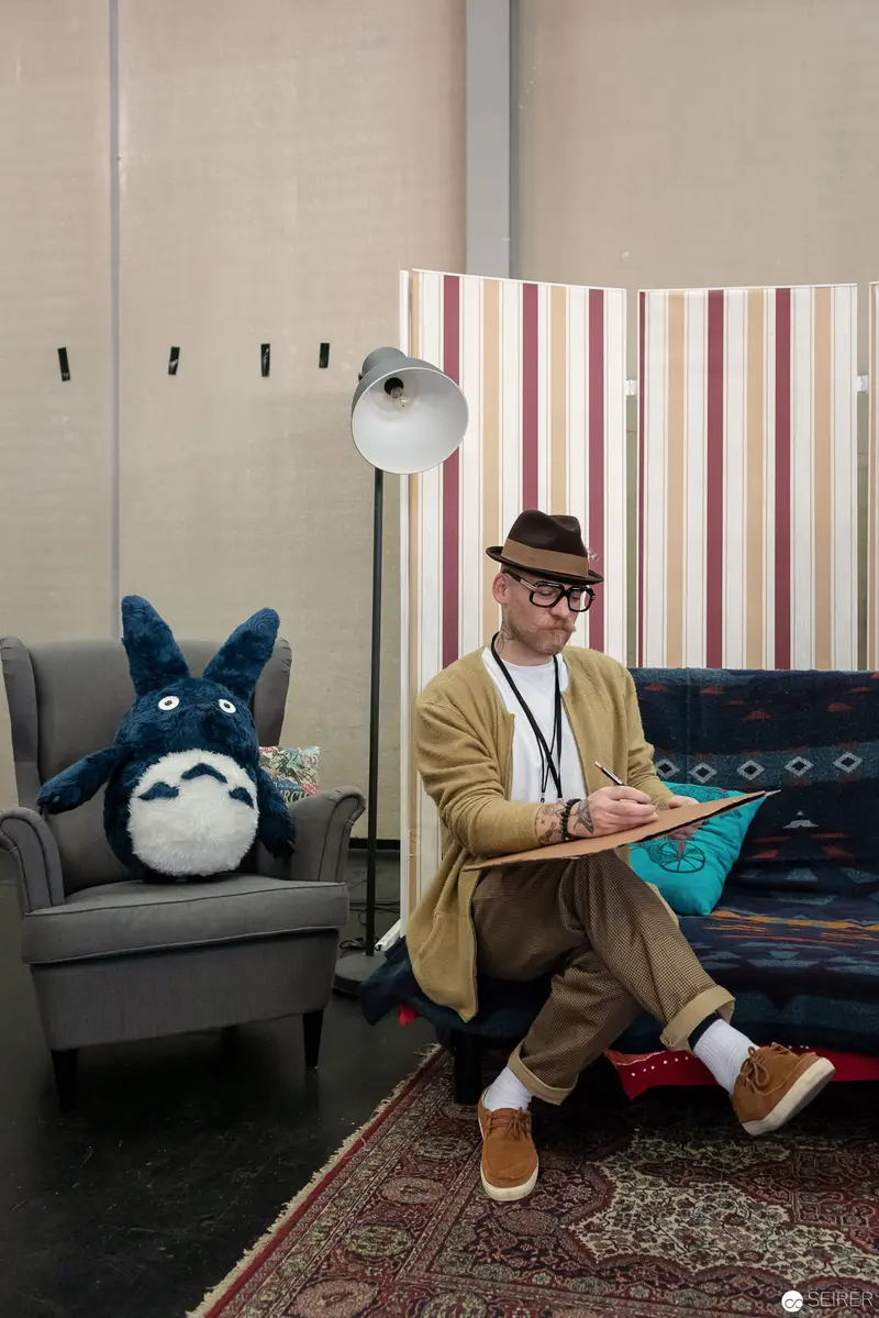 Studio Portrait of Artist with Totoro Plush and Vintage Aesthetic