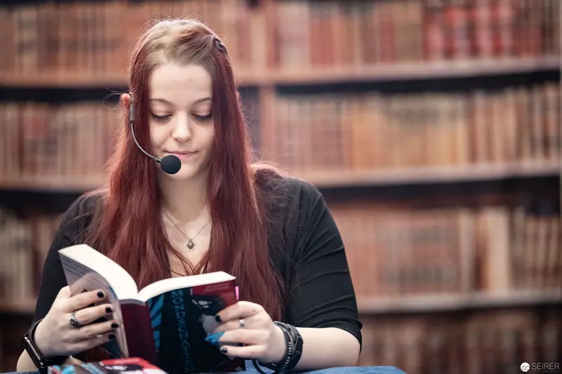 Young Scholar Reading in Library with Headset, Vienna ComicCon 2018
